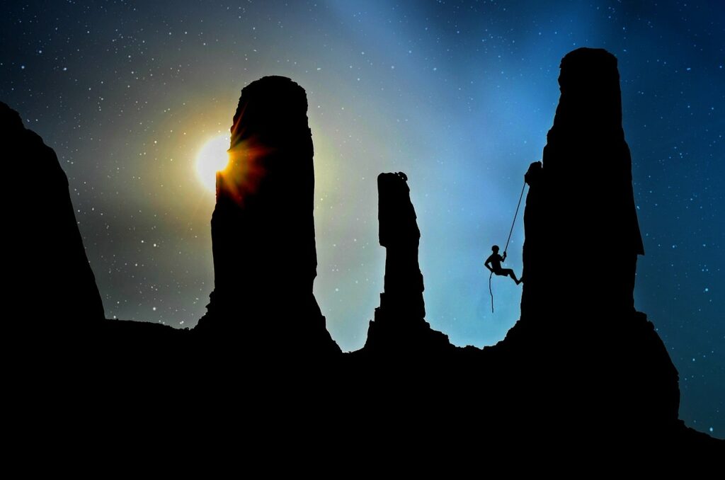 Rapelling Figure rapeling down a tower with sky in background