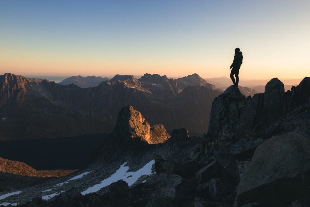 Figure on Mountain Figure atop a mountain looking at the view